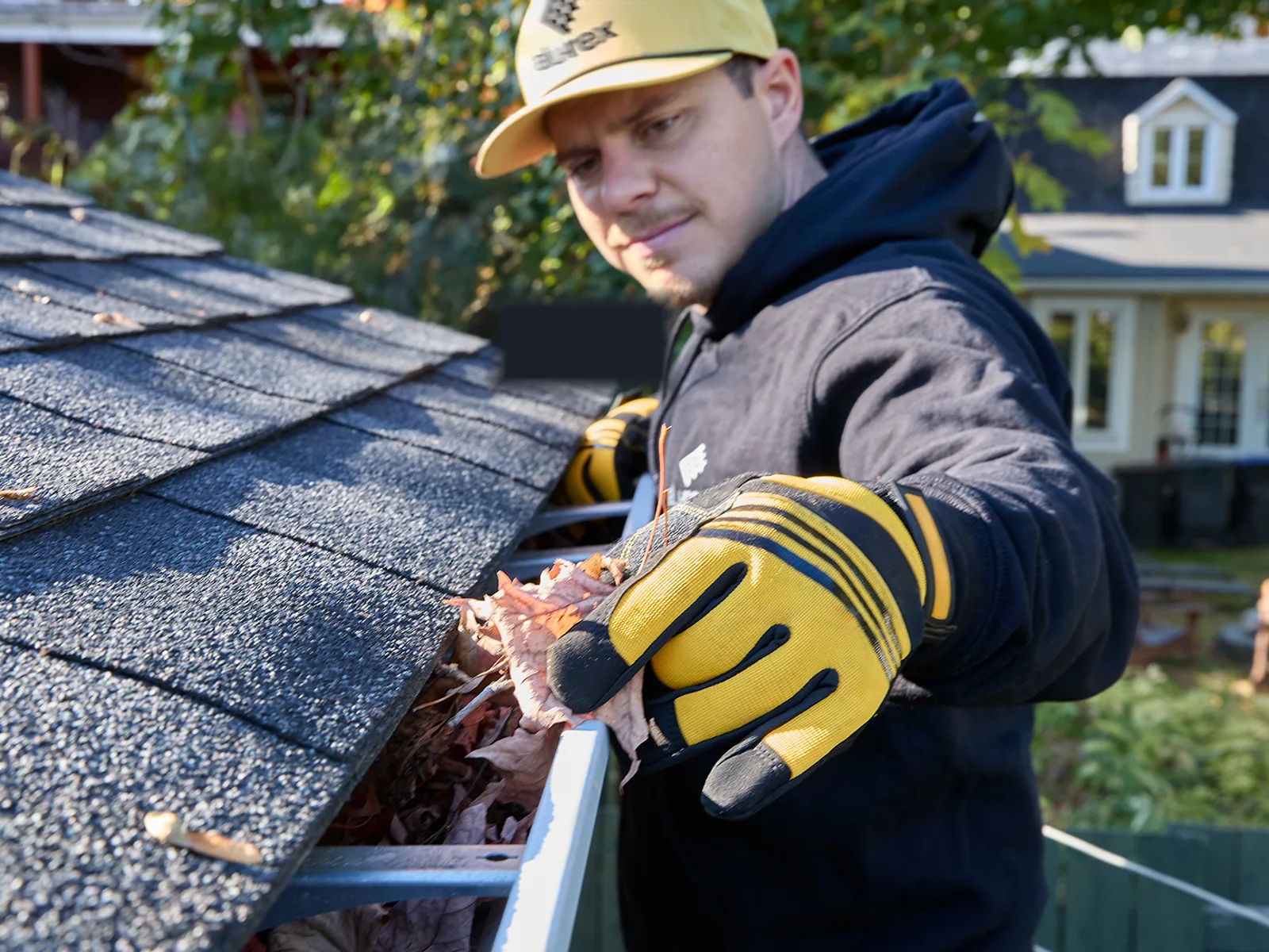 Installer preparing gutter materials on a residential job