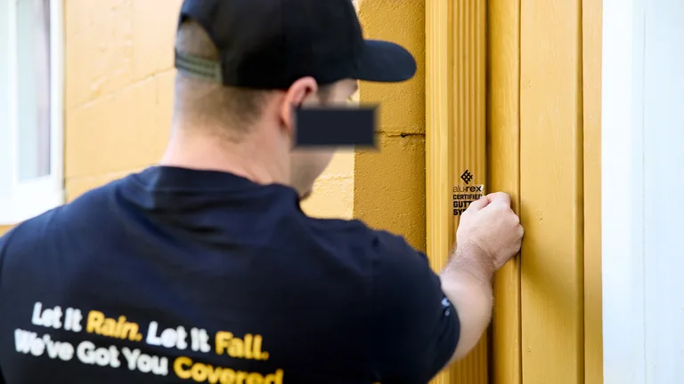 Technician knocking at a homeowner's door before a gutter job