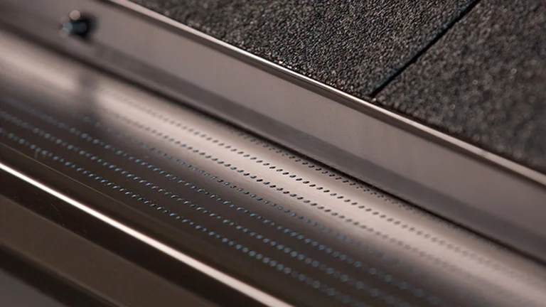 Close-up of the Alu-Rex DoublePro microfiltration continuous hanger on a shingle roof