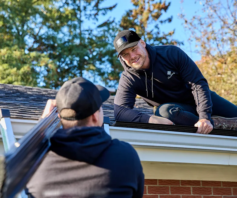 Two Good Gutters HFX installers working together at the roofline