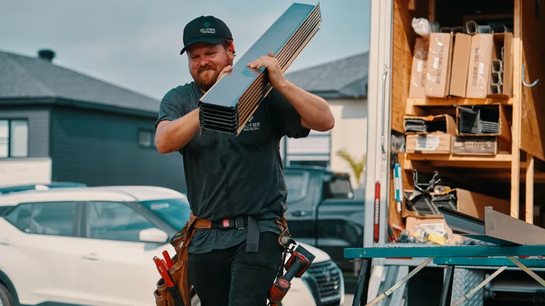 Alu-Rex DoublePro continuous hanger protecting a gutter from storm debris