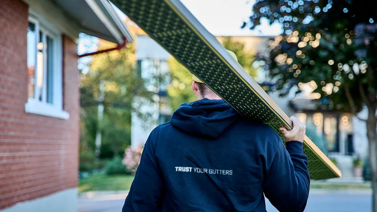 Close-up of professional gutter and continuous hanger installation