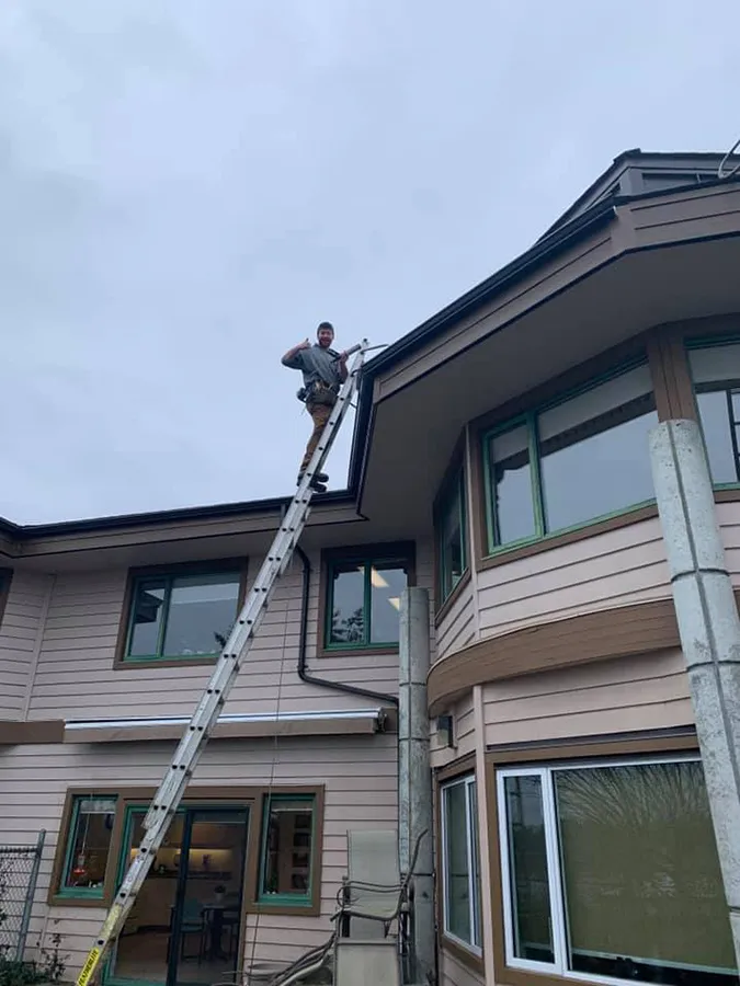 Downspout installation on a two-storey home — Mid Island Gutters, Parksville BC