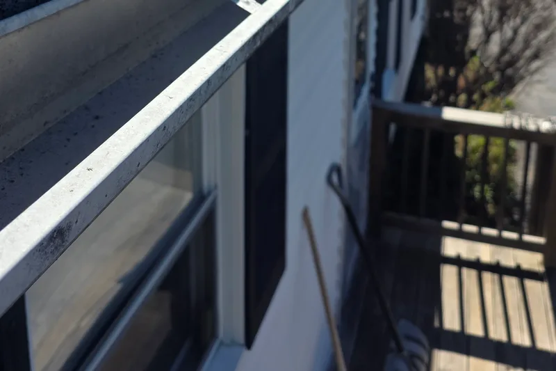 Aging gutter with failing spikes before repair