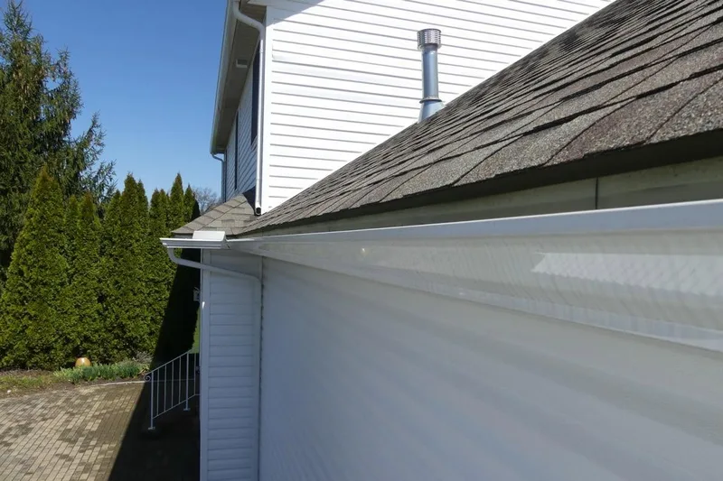 New white seamless gutter and downspout installed by Rainman Gutters